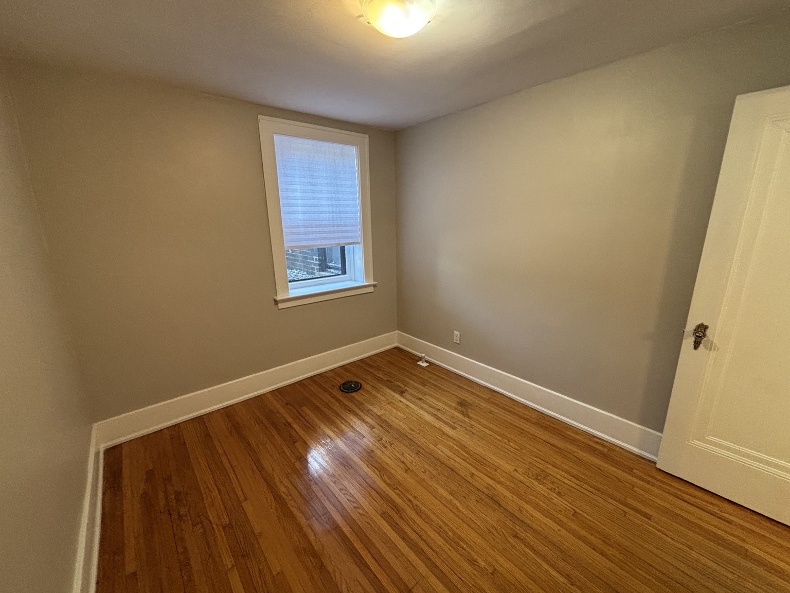 Bedroom with hardwood floor and single window — 430 Giles Blvd W., Windsor, Ontario