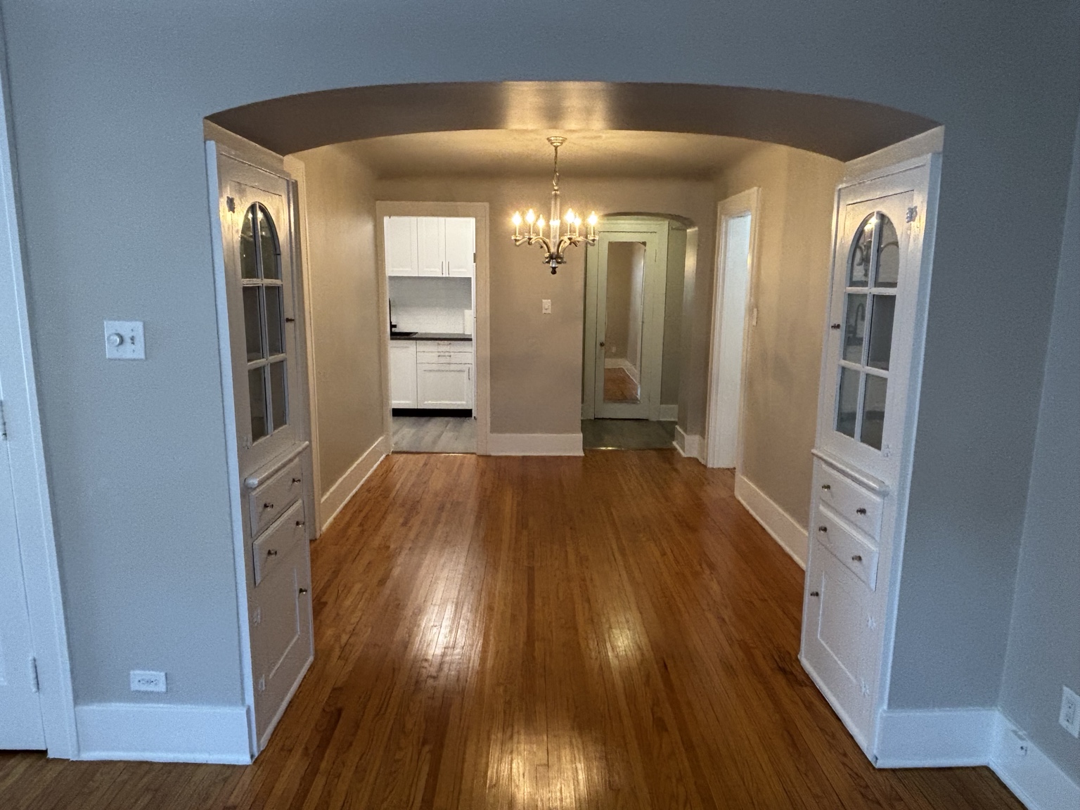 Dining room through an archway with built-in display cabinets — 430 Giles Blvd W., Windsor, Ontario