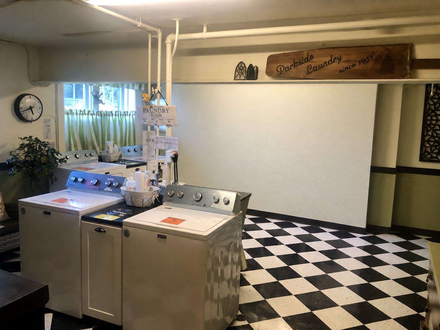 Laundry room — digitally edited to show a white wall; electrical meters are present in the actual room. — 430 Giles Blvd W., Windsor, Ontario